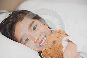 Smiling littlegirl with a teddy bear