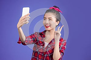 Smiling lovely active asian girl taking selfie photo.