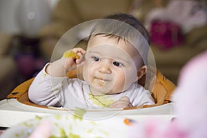 Smiling lovely baby with spoon