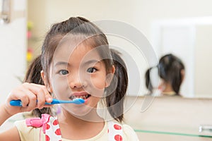 Smiling lovely children girl using toothbrush