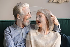 Smiling loving middle aged man and woman enjoying romantic moment
