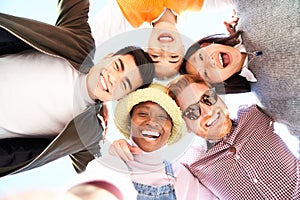 Smiling low angle circle selfie of cheerful group of young people. Happy friends excited having fun. Boys and