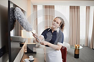 Smiling Maid Cleaning Hotel Room