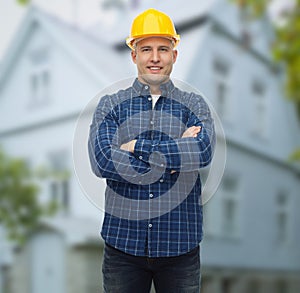 Smiling male builder or manual worker in helmet