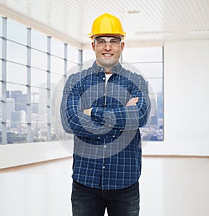 Smiling male builder or manual worker in helmet