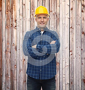 Smiling male builder or manual worker in helmet