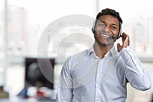 Smiling male call center agent talking to customer.