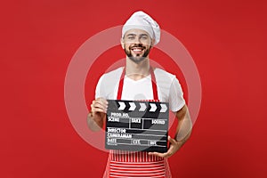 Smiling male chef cook or baker man in striped apron white t-shirt toque chefs hat isolated on red background. Cooking