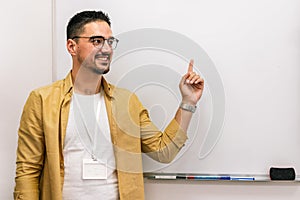 Smiling male coach presenting to an audience in the lecture hall