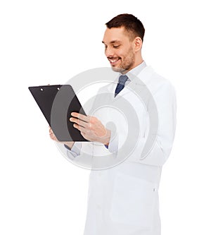 Smiling male doctor with clipboard
