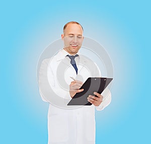 Smiling male doctor with clipboard