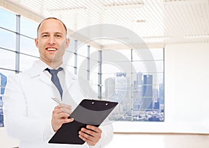 Smiling male doctor with clipboard