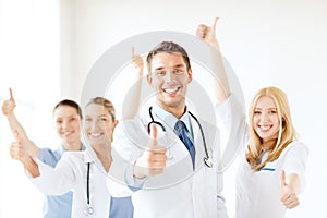 Smiling male doctor in front of medical group