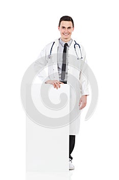 Smiling male doctor posing with empty poster