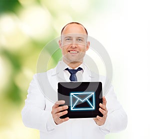 Smiling male doctor with tablet pc