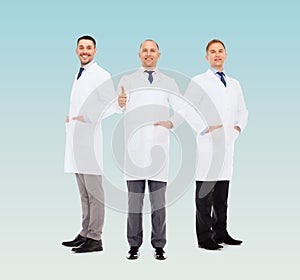 Smiling male doctors in white coats