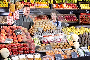 Smiling male and female shop assistants photo