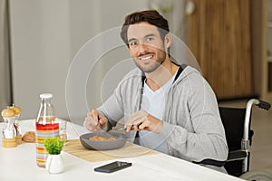 smiling male handicapped eating lunch