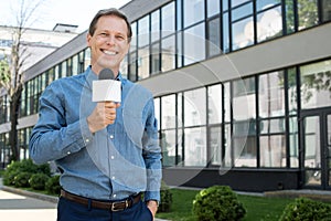 smiling male mature newscaster with microphone