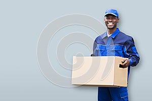 Smiling Male Mover Holding Package photo