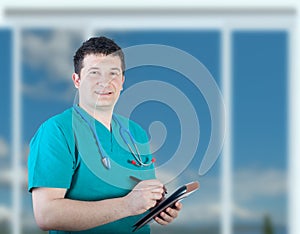Smiling male nurse taking notes
