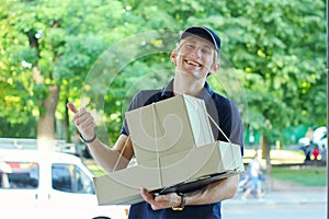 Smiling male postal delivery courier man outdoors