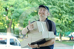 Smiling male postal delivery courier man outdoors