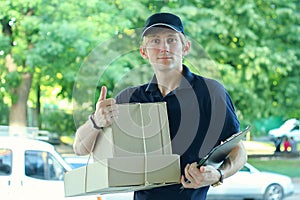 Smiling male postal delivery courier man outdoors