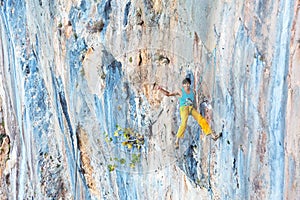 Smiling male Rock Climber descending on Rope with Okey hand sign photo
