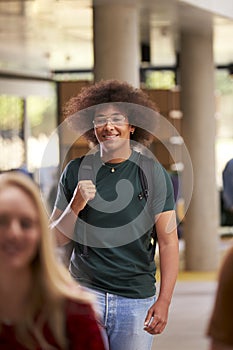 Smiling Male Student In Busy University Or College Building