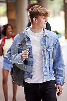 Smiling Male Student In Busy University Or College Building