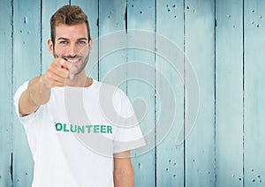 Smiling male volunteer pointing at camera
