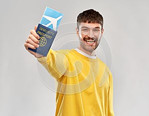 smiling man with air ticket and immunity passport