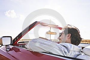 Man behind the wheel of car while road trip