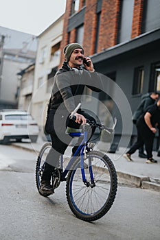 Smiling man on a bicycle talking on the phone in an urban setting