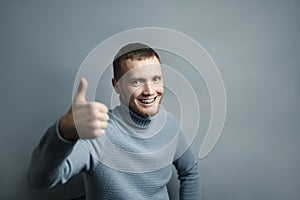 Smiling man with brackets shows thumb up