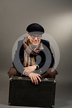 Smiling man in cap sitting