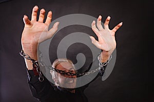 Smiling man with chained hands, no freedom