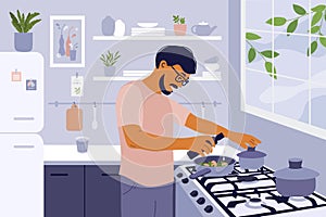Smiling man cooking healthy meals in small cozy kitchen