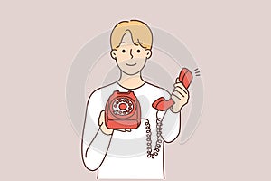 Smiling man with corded phone offer to make call