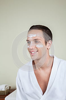 Smiling man with cream on his face