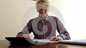 Smiling Man Does an Office Excercise While Sitting at His Table