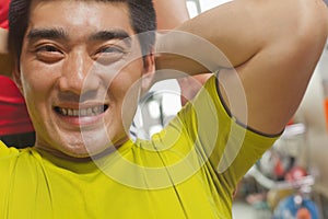 Smiling man doing sit ups, looking at camera