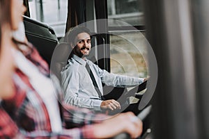 Smiling Man Driving Tour Bus. Professional Driver