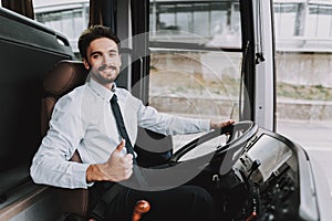 Smiling Man Driving Tour Bus. Professional Driver