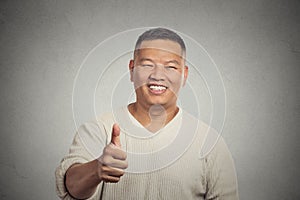 Smiling man employee giving thumbs up sign gesture