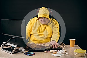 Smiling man enjoying playing computer games online