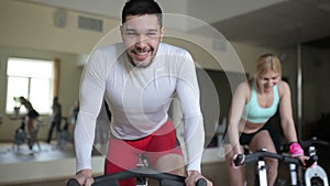 Smiling man on the exercise bike