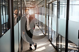 Smiling man facing camera in hallway of office