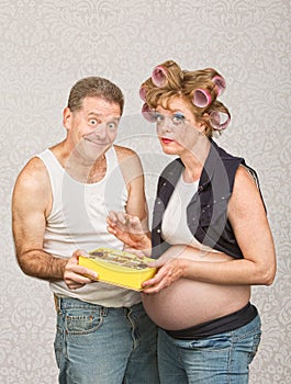 Smiling Man Feeding Pregnant Woman